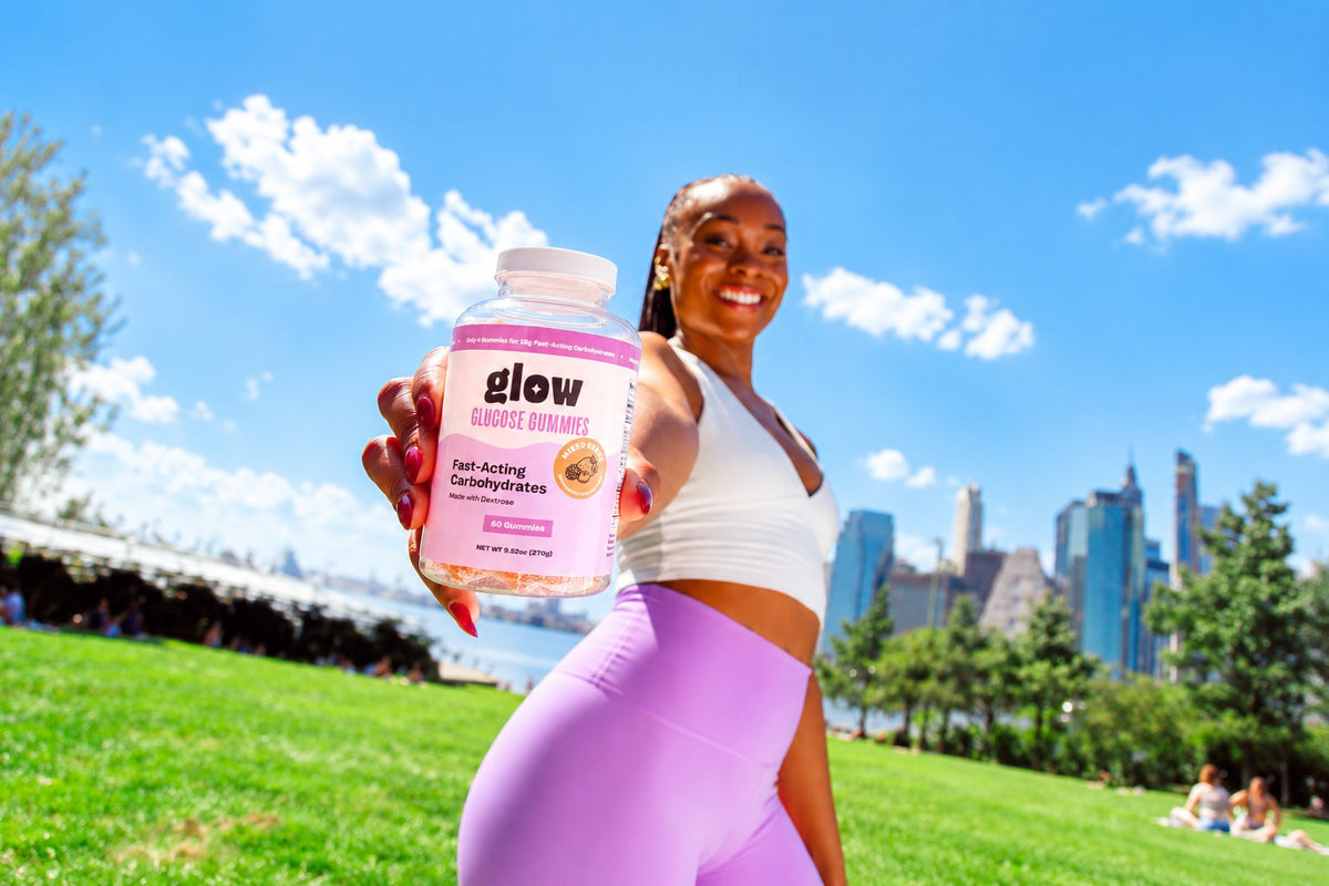Glow Gummies homepage hero, woman in a park holding a Mixed Berry bottle